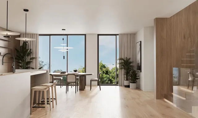 a view of a livingroom with furniture and floor to ceiling window