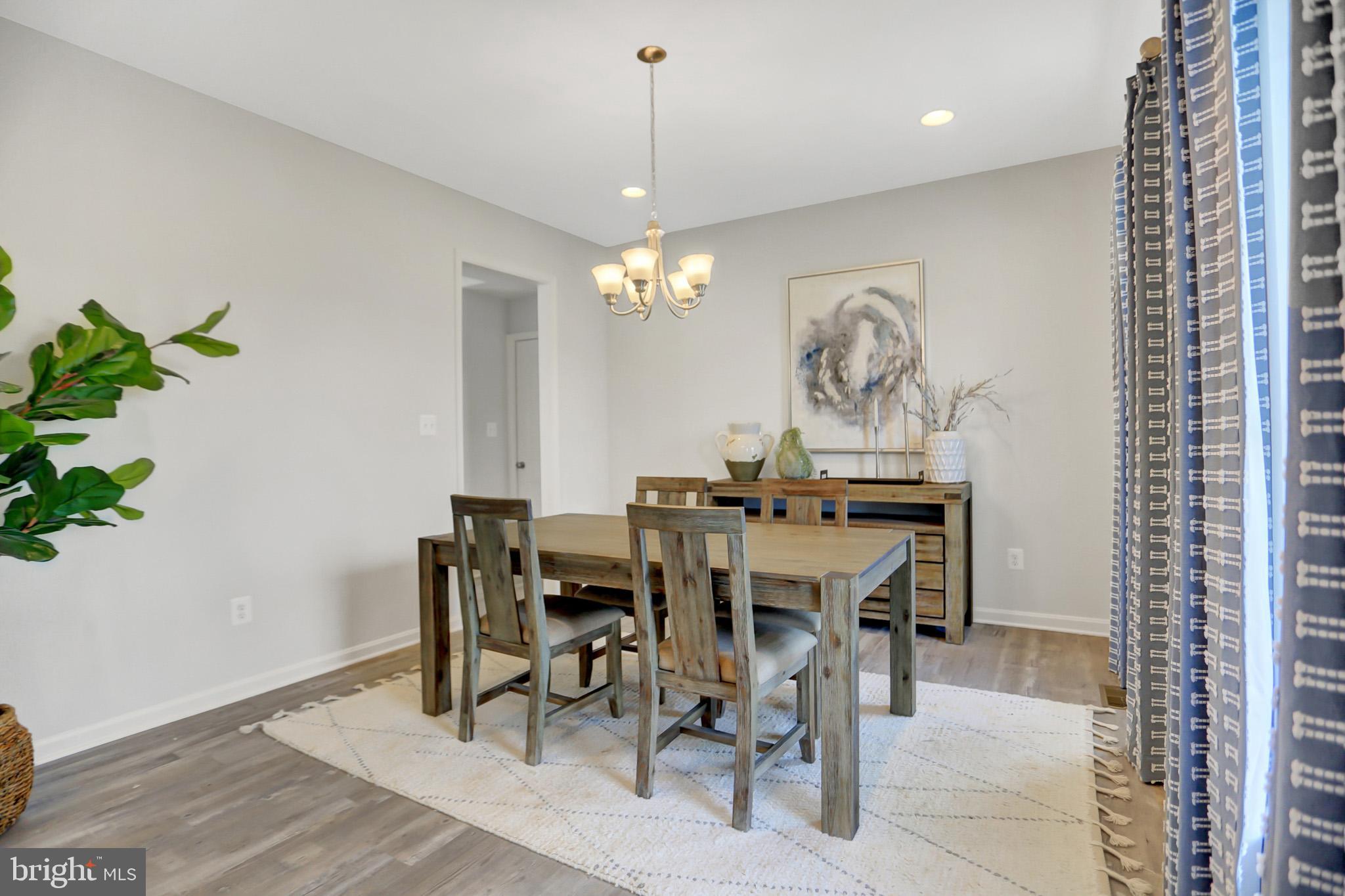 104 Singer Road Abingdon, MD 21009 - Photo 11 of 22 a view of a dining room with furniture and chandelier