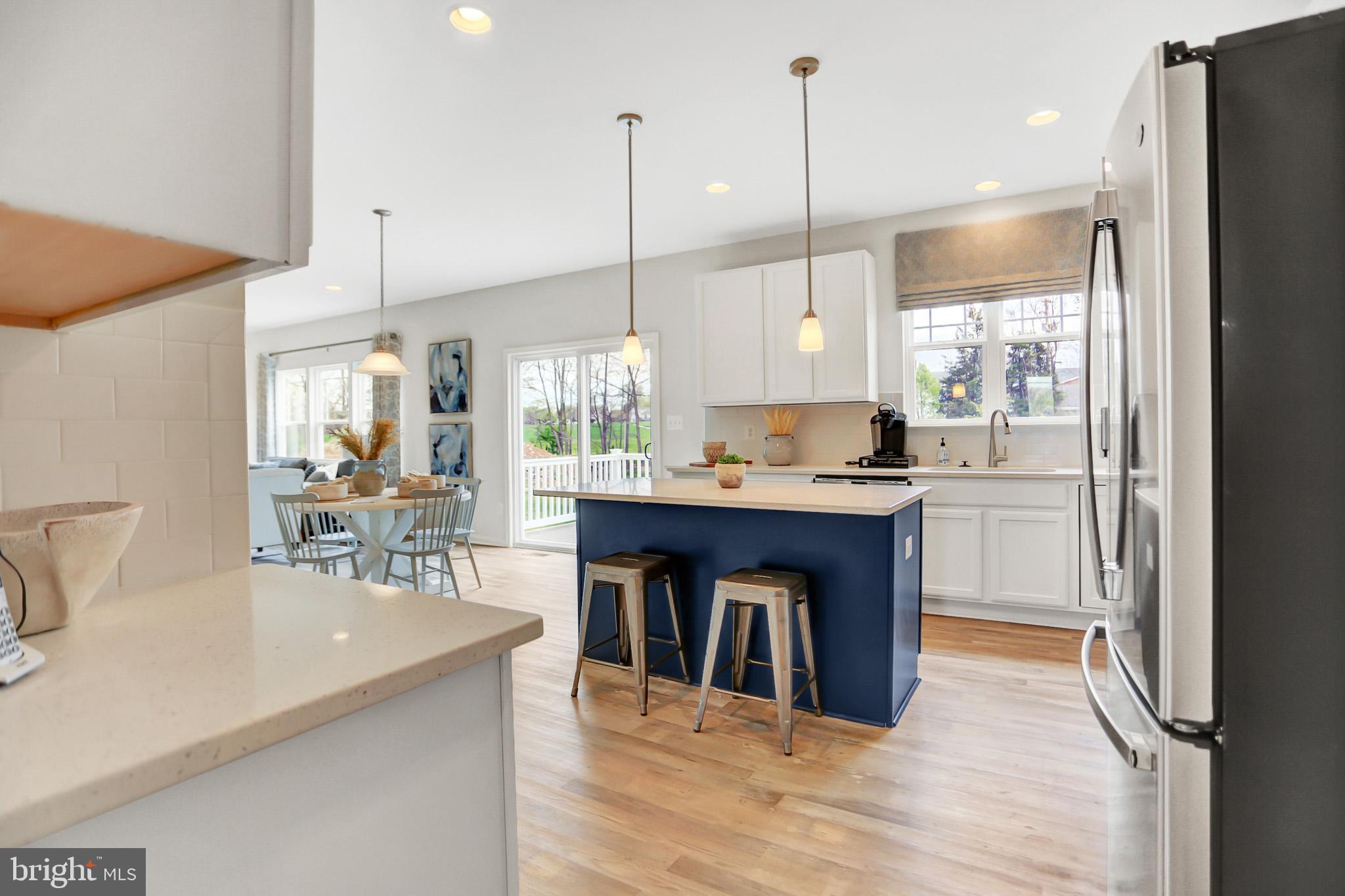 104 Singer Road Abingdon, MD 21009 - Photo 17 of 22 a kitchen with stainless steel appliances granite countertop a refrigerator a sink a stove and a wooden floors
