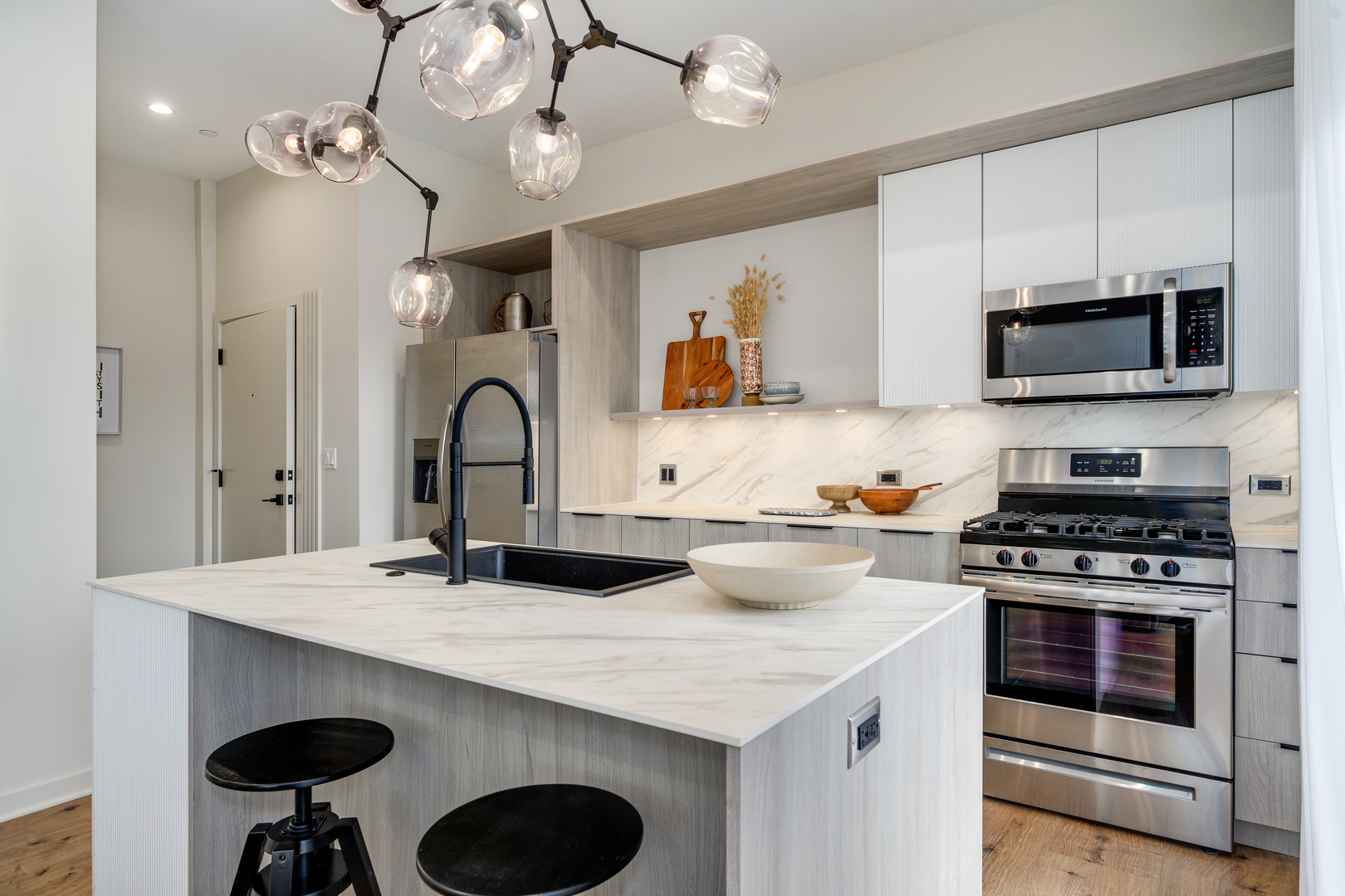 11 West Prospect Avenue, Unit 415 Mount Prospect, IL 60056 - Photo 11 of 62 a kitchen with a sink a stove and chairs with wooden floor