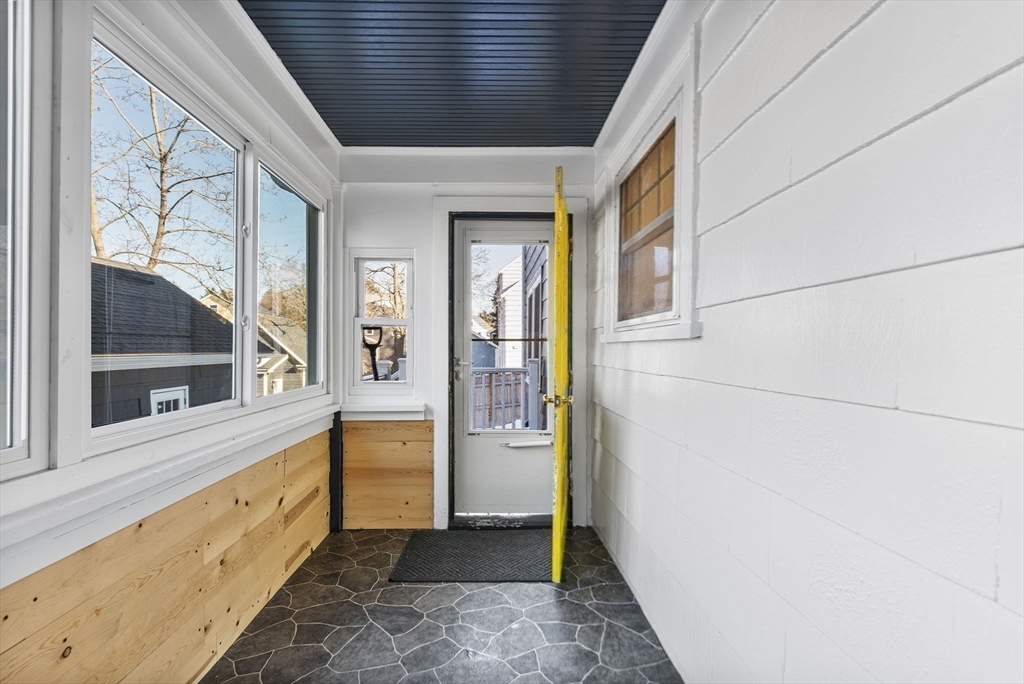 424 Brook Road Milton, MA 02186 - Photo 13 of 41 a view of a hallway with wooden floor and furniture