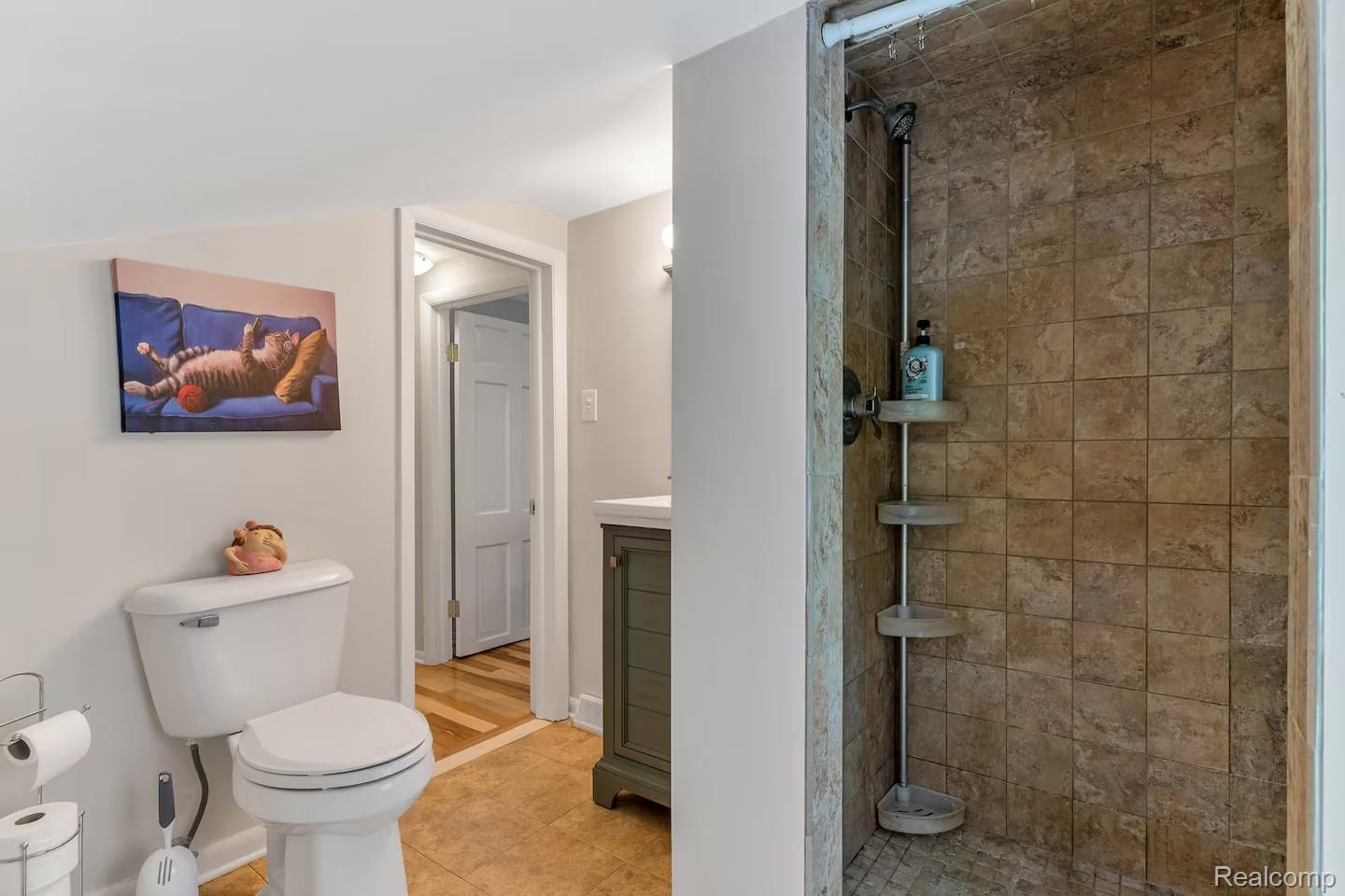 4567 North Seymour Road Flushing, MI 48433 - Photo 17 of 43 Tiled shower stall with an integrated corner shelving unit and a white ceiling-mounted shower curtain rod