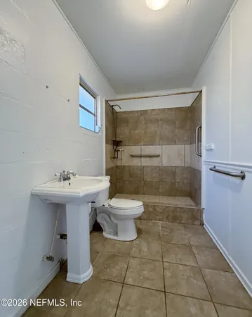 a bathroom with a sink toilet and shower