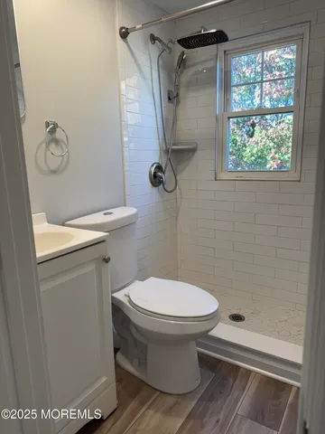 a bathroom with a toilet and a shower