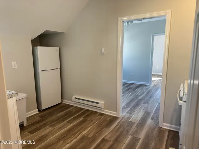 a view of a room with wooden floor