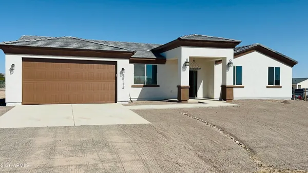 a view of a house with a wooden fence