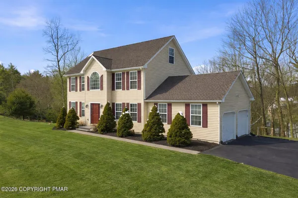 a front view of a house with a yard