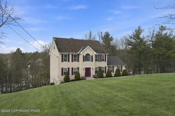 a view of house with a big yard
