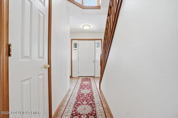 a view of hallway with wooden floor