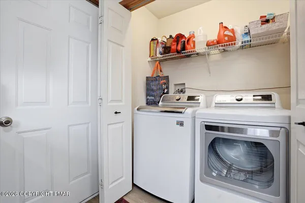 a kitchen with white cabinets and sink