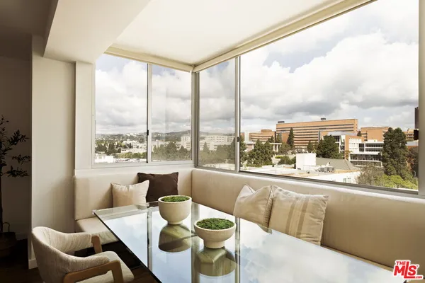 a living room with furniture and floor to ceiling windows