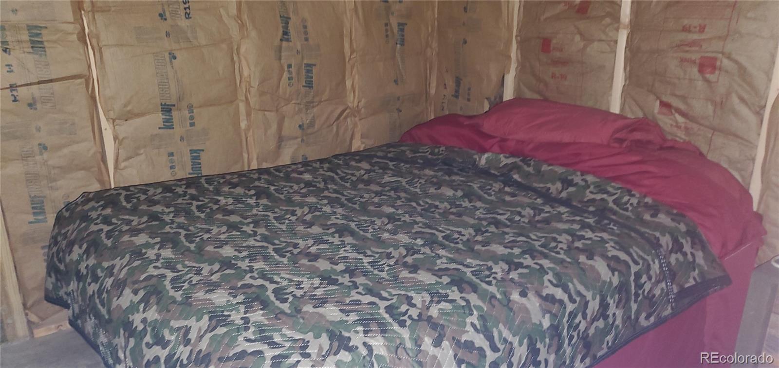 6601 Heckman Road San Luis, CO 81152 - Photo 16 of 28 a bed sitting in a bedroom next to a shower