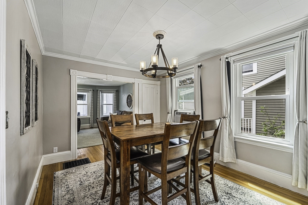 4 Collins Street Amesbury, MA 01913 - Photo 12 of 32 a dining room with furniture a chandelier and wooden floor
