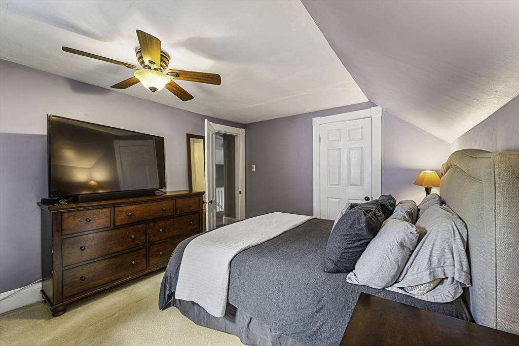 4 Collins Street Amesbury, MA 01913 - Photo 17 of 32 a bedroom with a bed and a flat screen tv