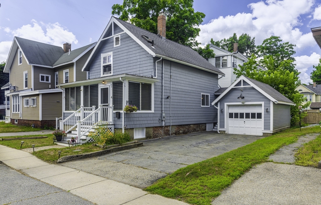 4 Collins Street Amesbury, MA 01913 - Photo 2 of 32 a front view of a house with a yard table and chairs