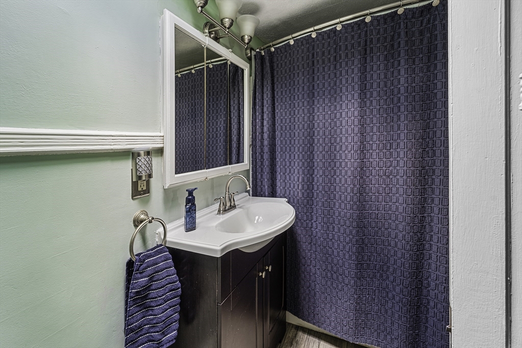 4 Collins Street Amesbury, MA 01913 - Photo 24 of 32 a bathroom with a sink and a mirror