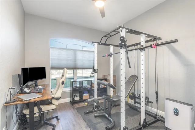 a view of a livingroom with workspace and a window