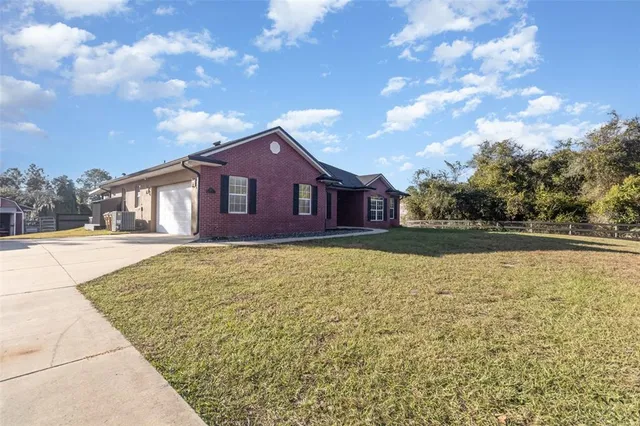 a view of pool with a yard