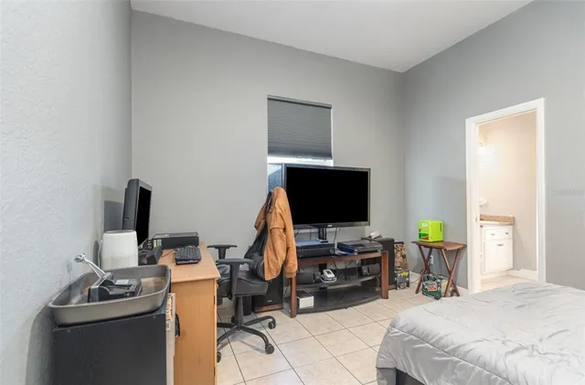 a bedroom with a workspace