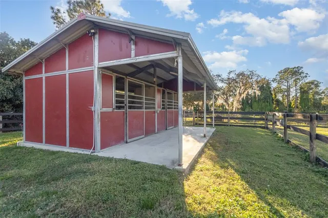 a view of an house with backyard and porch
