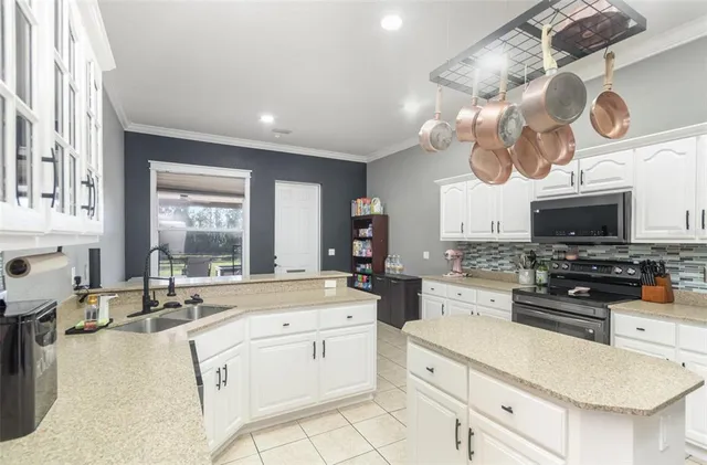 a kitchen with stainless steel appliances a stove a sink and a refrigerator