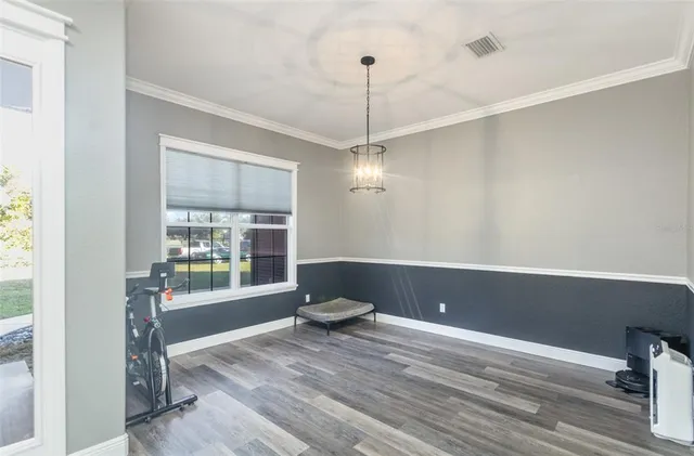 a view of a livingroom with wooden floor and a window
