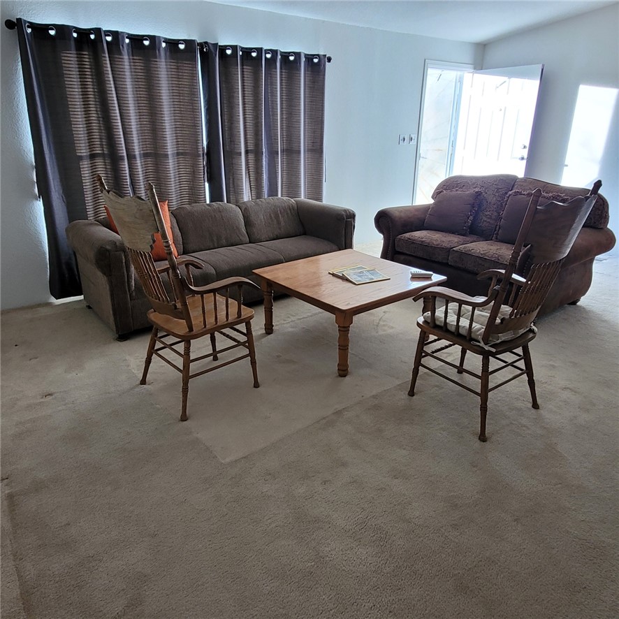 9732 2nd Street Chloride, AZ 86431 - Photo 12 of 28 The living area features wall-to-wall carpeting and offers natural light from the windows