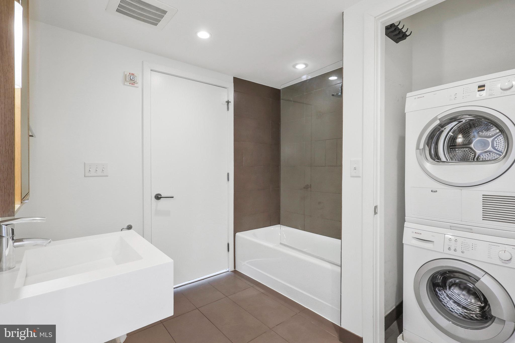 1515 15th Street Northwest, Unit 428 Washington, DC 20005 - Photo 16 of 30 Modern bathroom with laundry convenience.