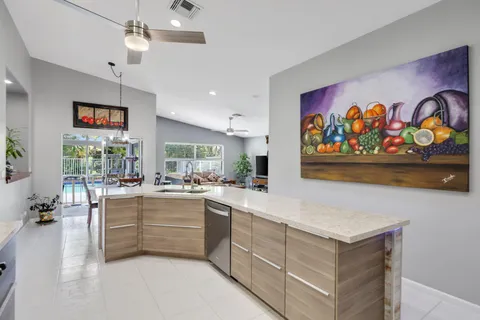 a view of a dining room with furniture a chandelier and window