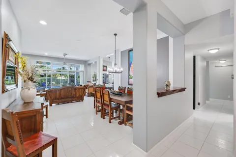 a living room with furniture a flat screen tv and a large window
