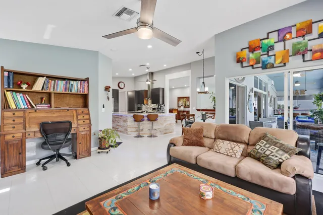 a living room with furniture and a potted plant