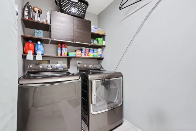 a view of a hallway with a chandelier and glass door