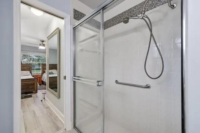a bathroom with a two sinks a large mirror and a bathtub next to a window