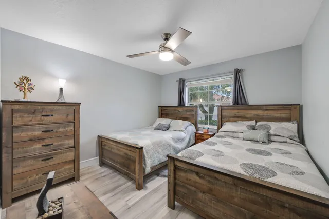 a living room with furniture a large window and plants