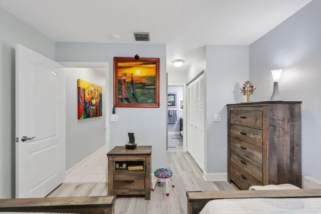 a living room with patio furniture and a potted plant
