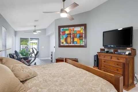 a view of a swimming pool with a patio and a garden