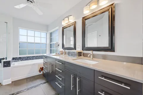 an aerial view of residential houses with outdoor space and trees