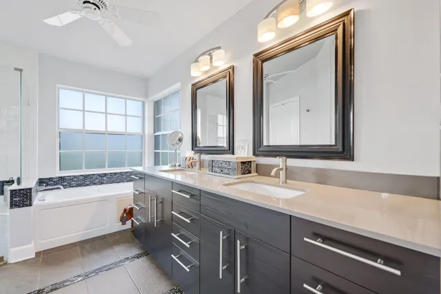 an aerial view of residential houses with outdoor space and trees
