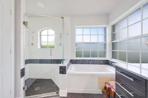 an aerial view of residential houses with outdoor space and lake view