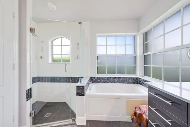 an aerial view of residential houses with outdoor space and lake view