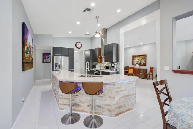 a view of kitchen with microwave stove top oven and cabinets
