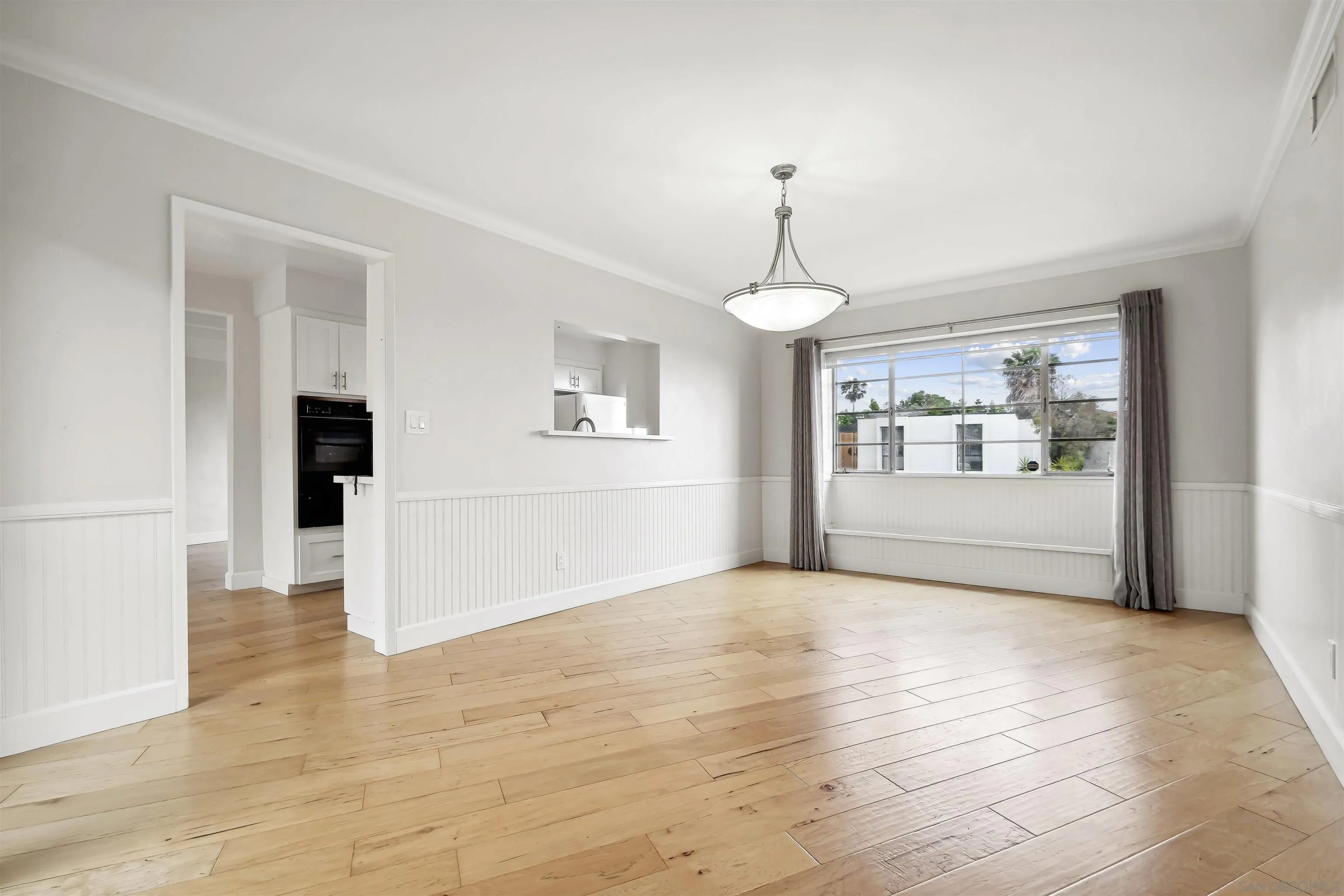 838 Lamplight Drive La Jolla, CA 92037 - Photo 13 of 42 a view of an empty room with window and wooden floor