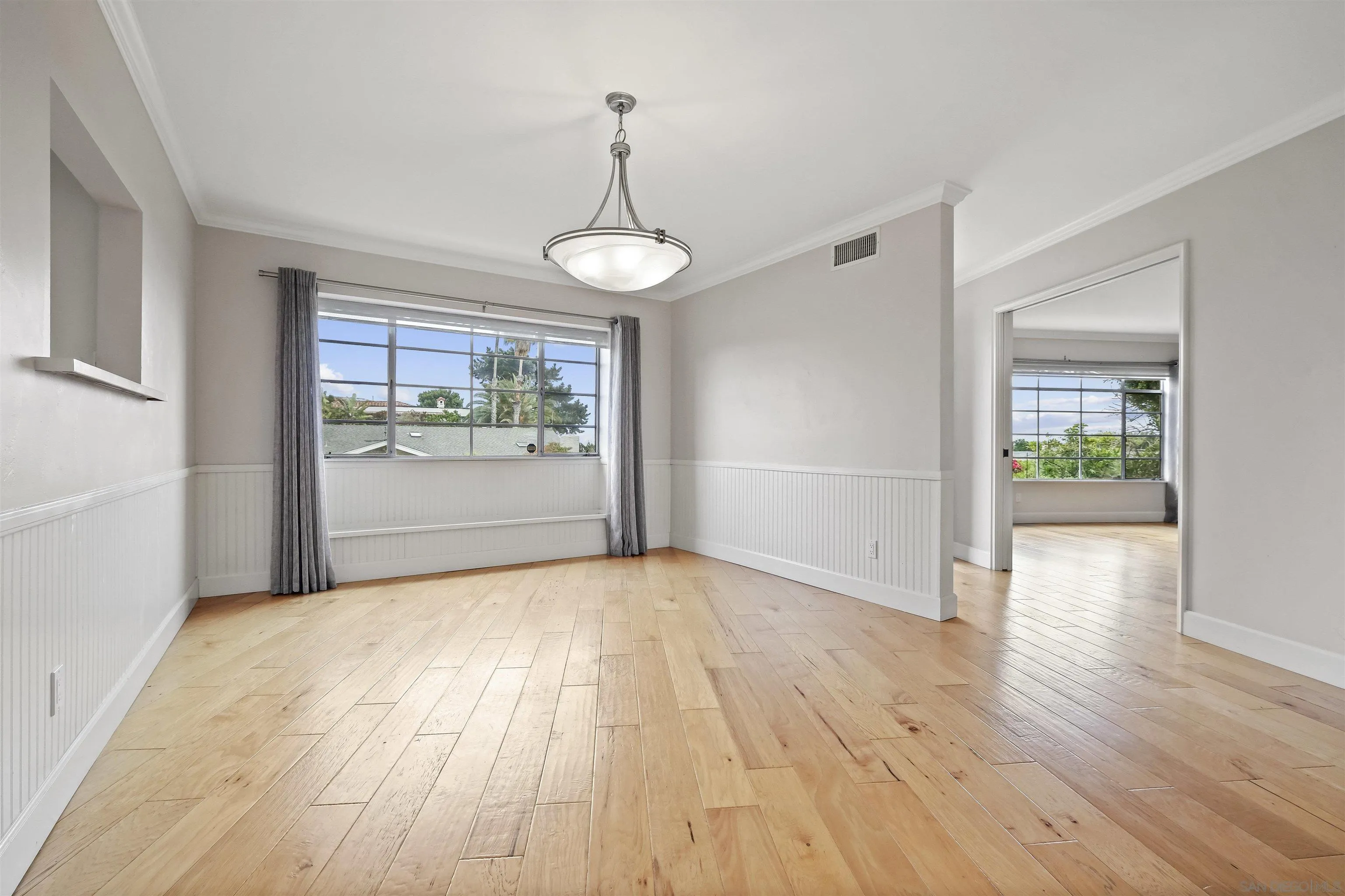 838 Lamplight Drive La Jolla, CA 92037 - Photo 14 of 42 a view of an empty room with a window and wooden floor