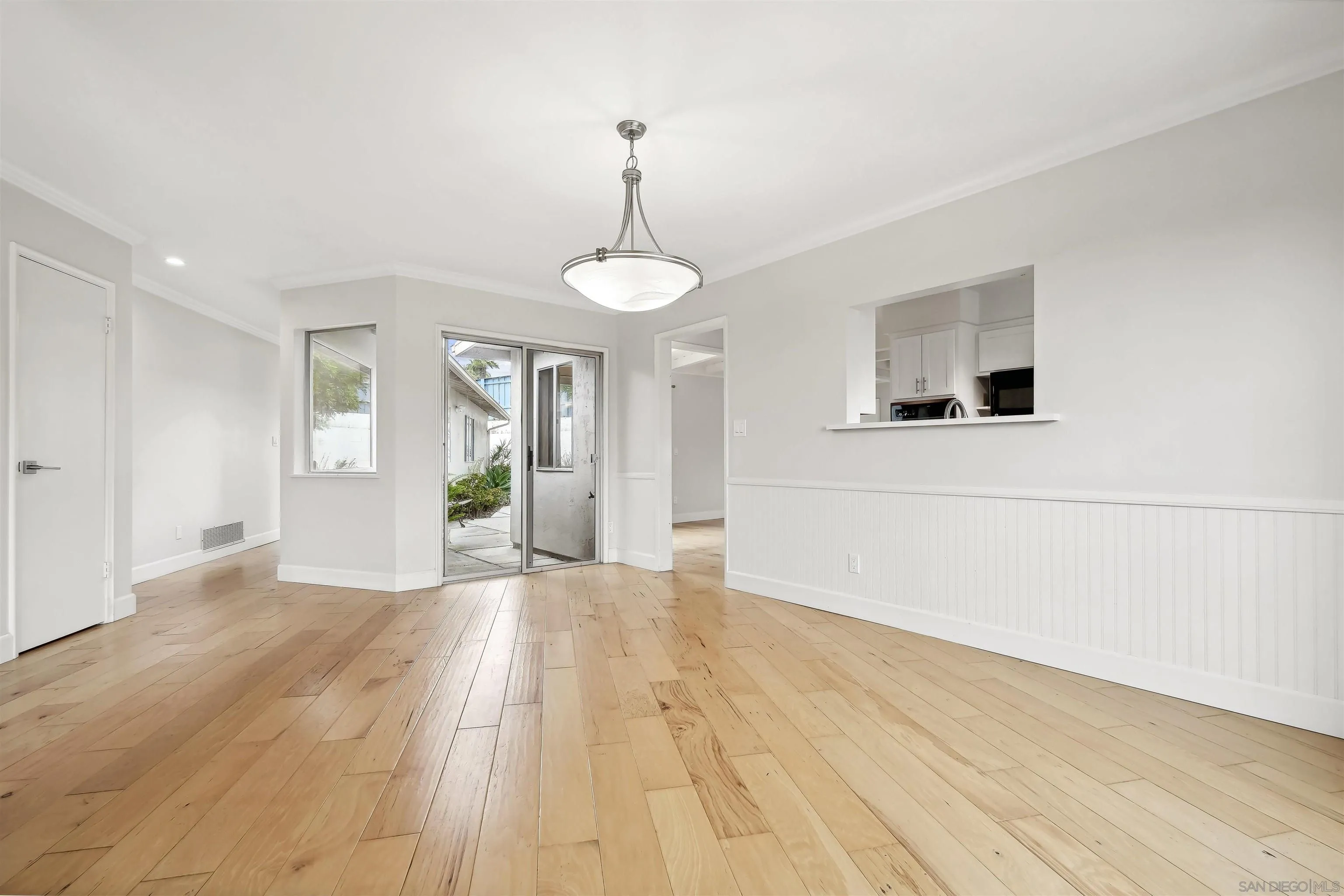 838 Lamplight Drive La Jolla, CA 92037 - Photo 15 of 42 a view of an empty room with window and wooden floor