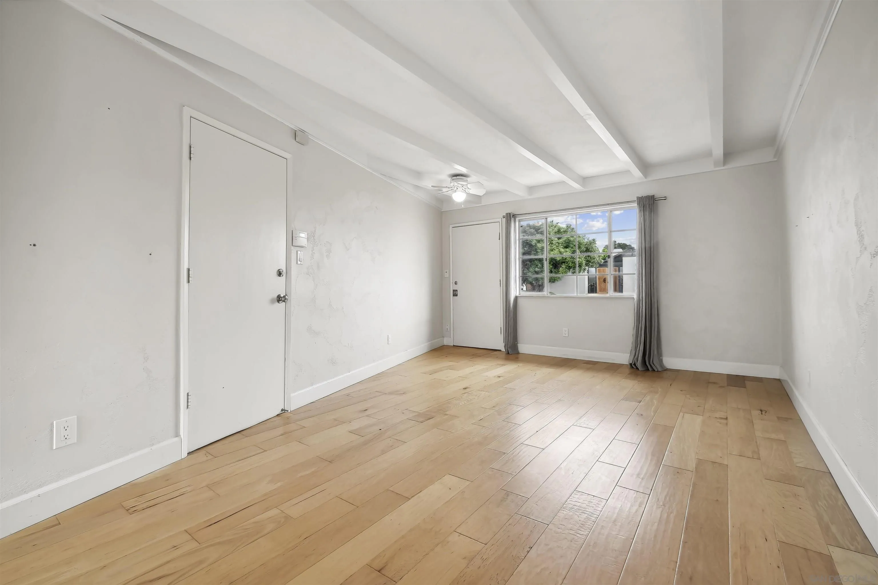 838 Lamplight Drive La Jolla, CA 92037 - Photo 17 of 42 a view of empty room with wooden floor and fan