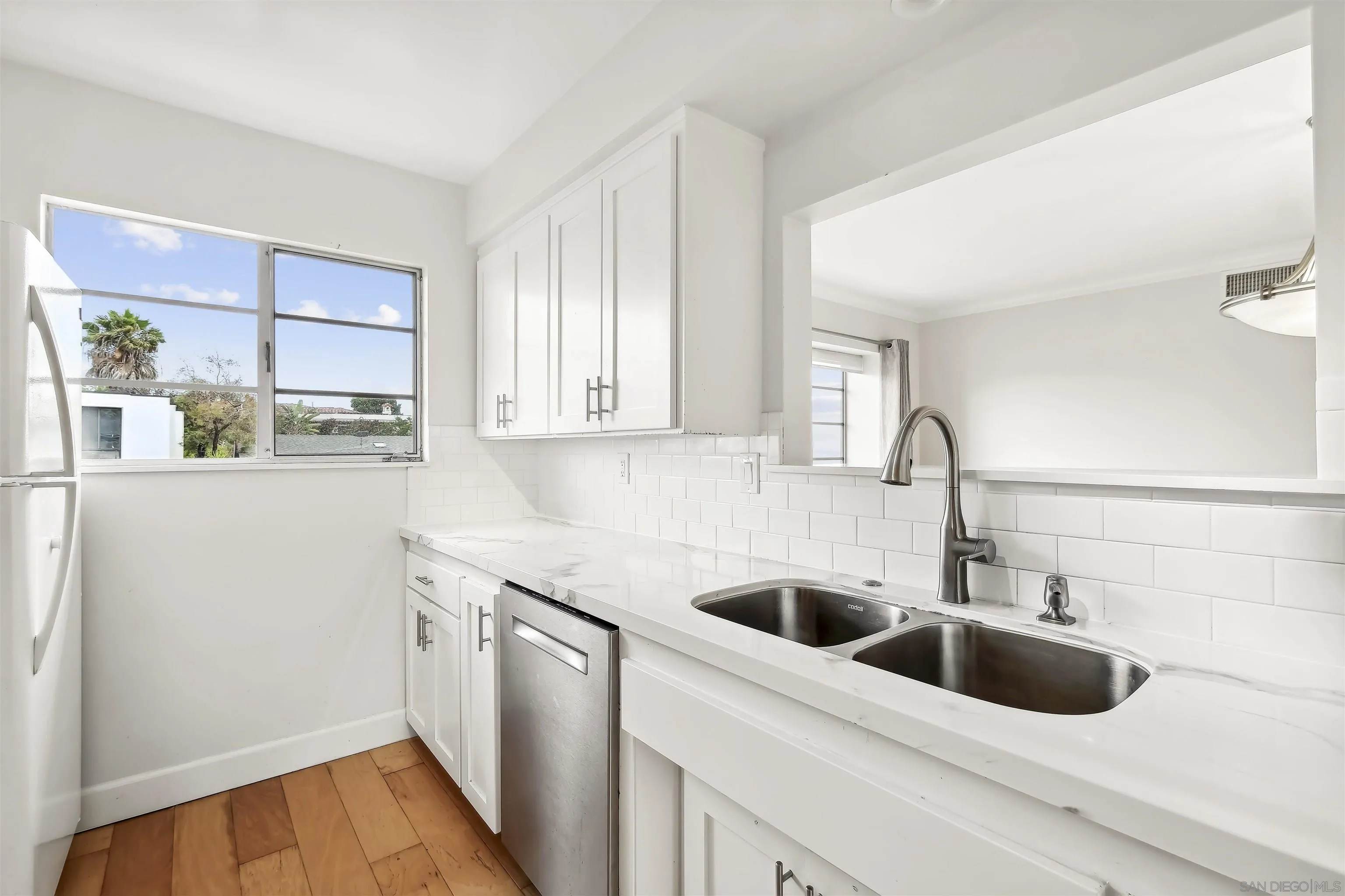 838 Lamplight Drive La Jolla, CA 92037 - Photo 20 of 42 a kitchen with a sink and a refrigerator