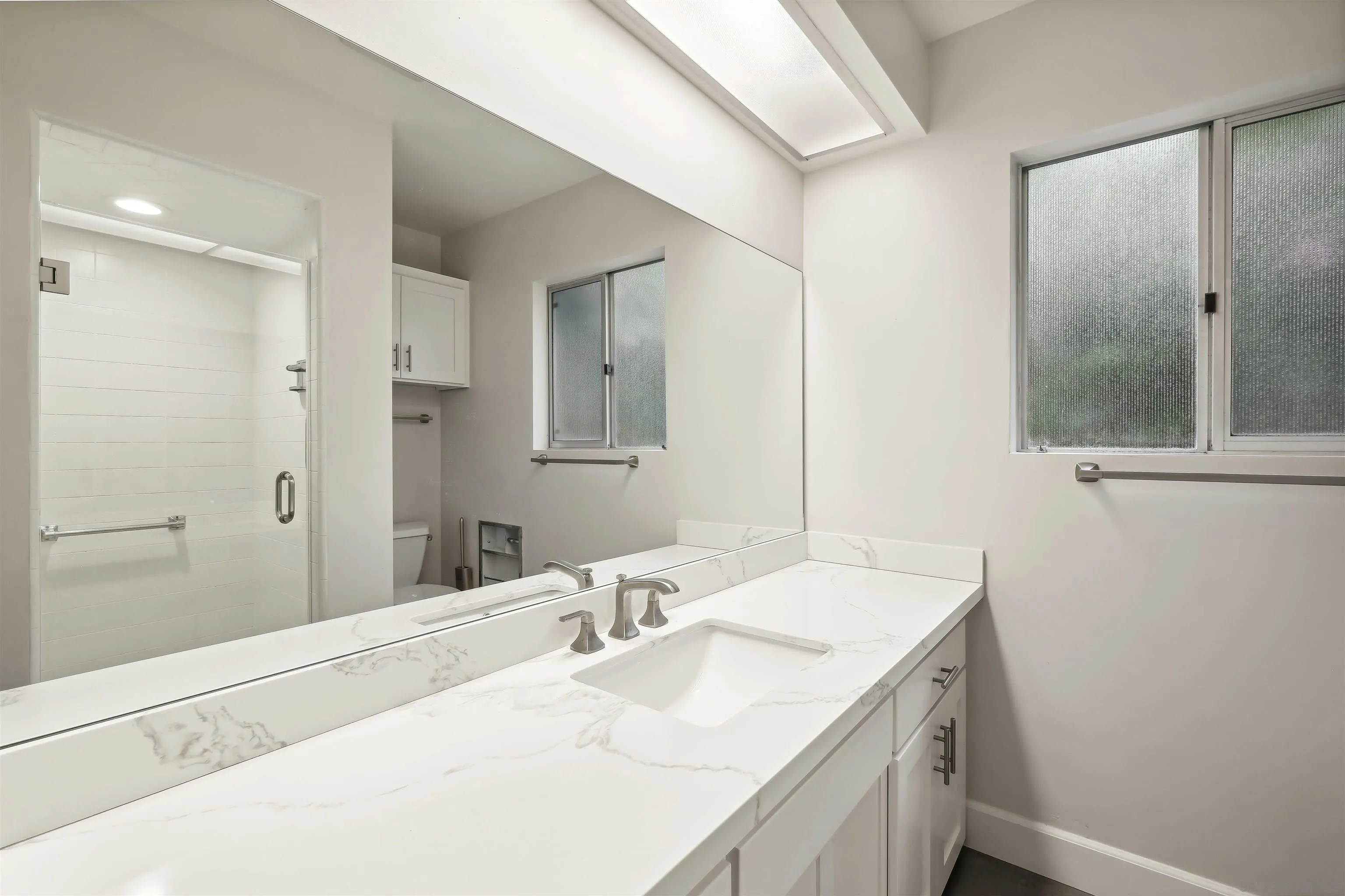 838 Lamplight Drive La Jolla, CA 92037 - Photo 26 of 42 a bathroom with a sink and a mirror