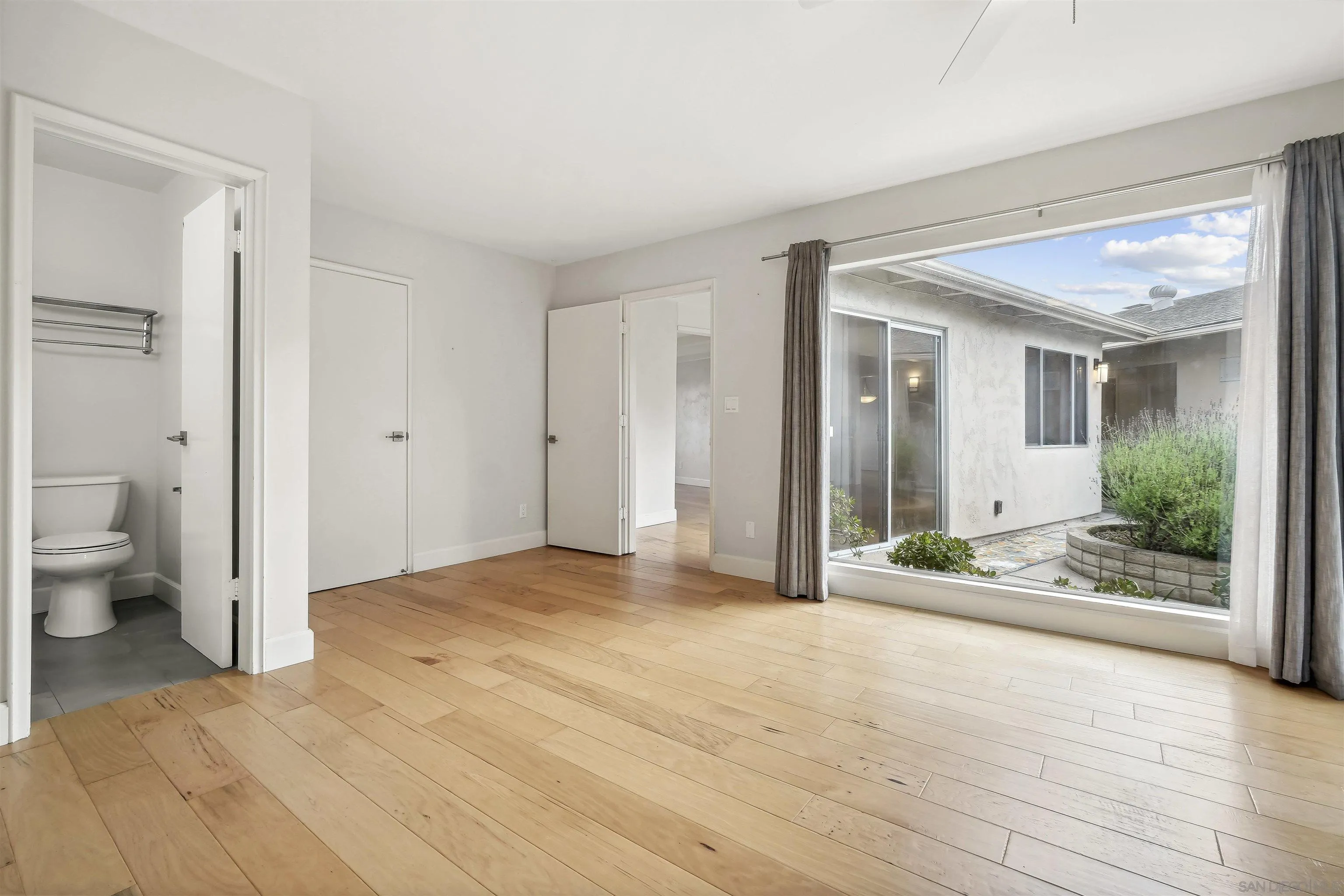 838 Lamplight Drive La Jolla, CA 92037 - Photo 28 of 42 a view of a bathroom with a sink and a mirror