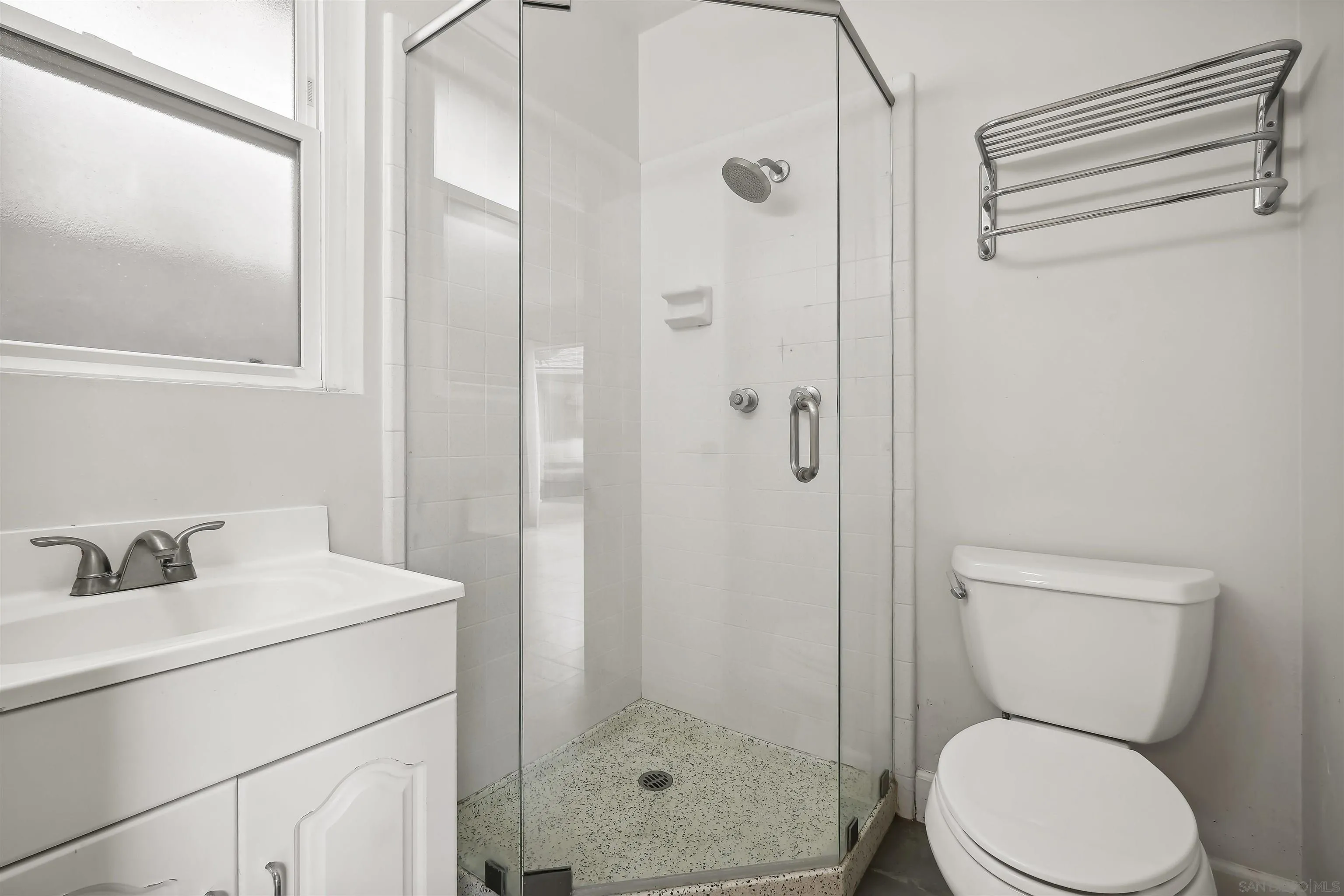 838 Lamplight Drive La Jolla, CA 92037 - Photo 30 of 42 a bathroom with a toilet sink vanity and shower