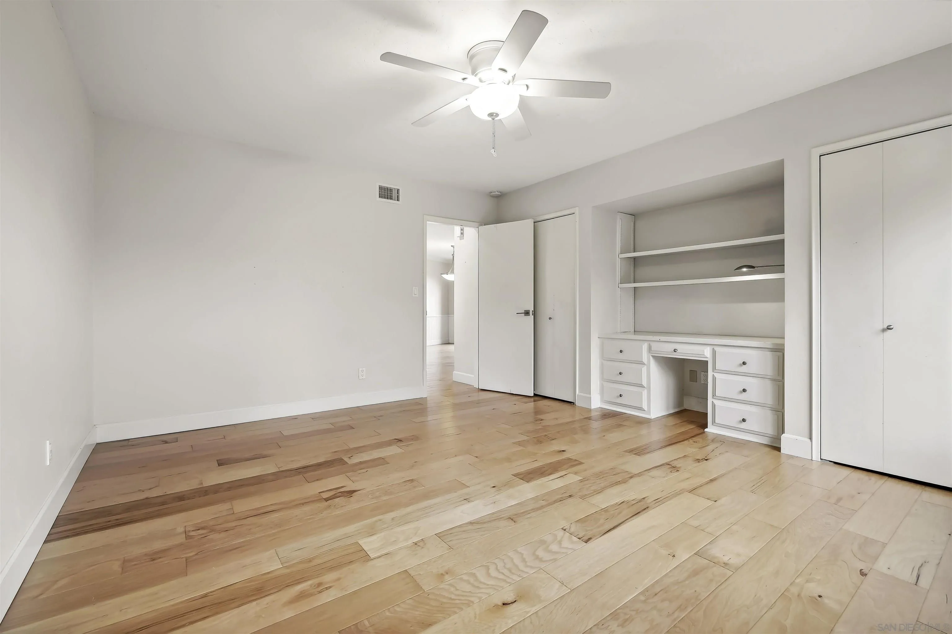 838 Lamplight Drive La Jolla, CA 92037 - Photo 32 of 42 a view of a big room with closet and a ceiling fan